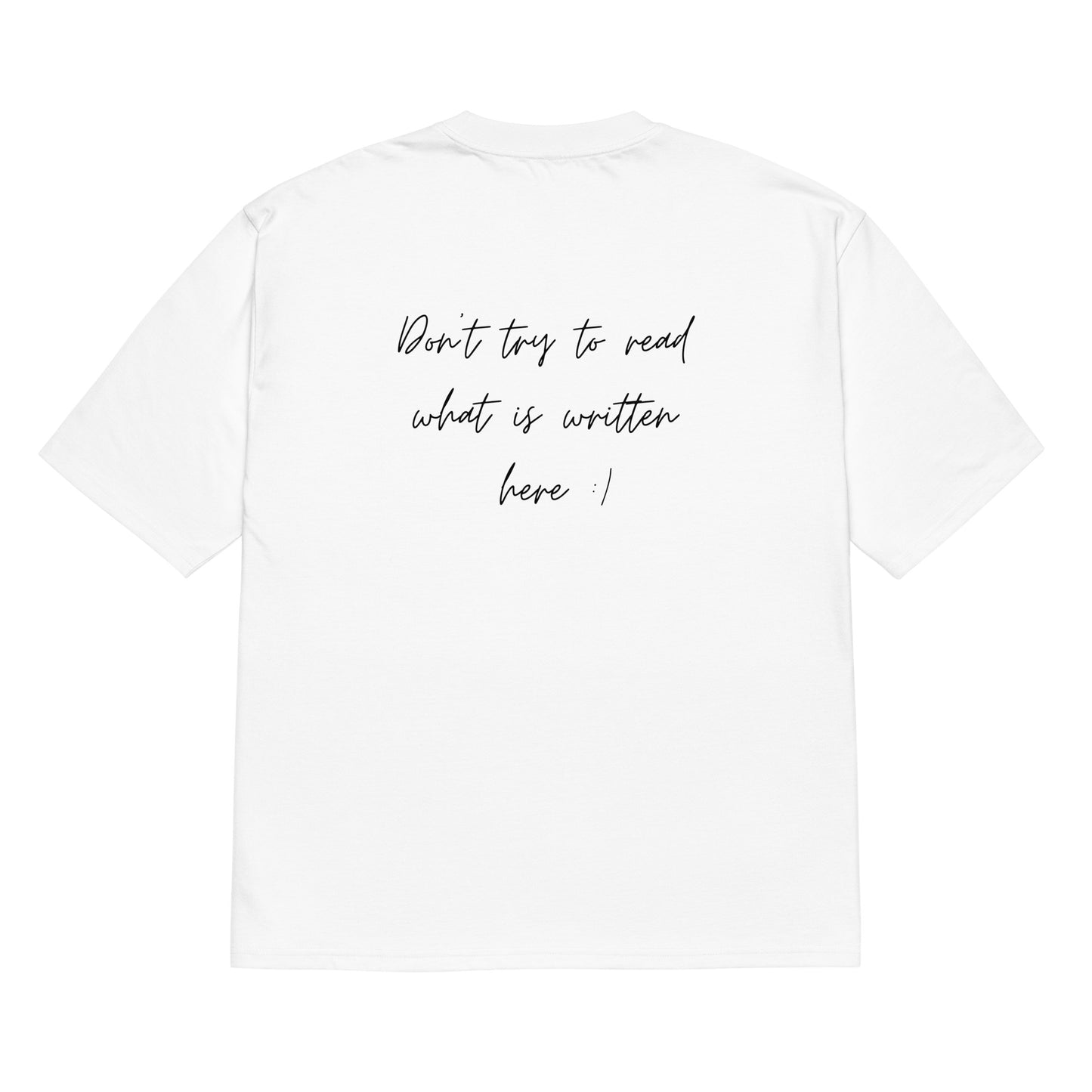 White oversized t-shirt with a slogan on its back in a quirky font - don't try to read what is written here. Heavyweight oversized t-shirt