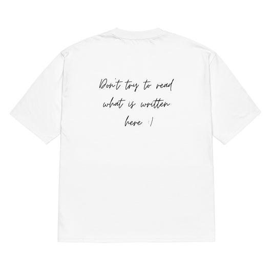 White oversized t-shirt with a slogan on its back in a quirky font - don't try to read what is written here. Heavyweight oversized t-shirt